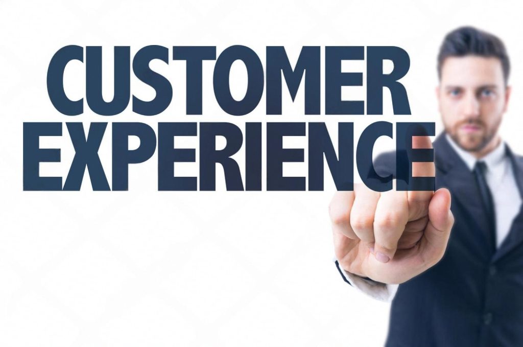 Businessman pointing at the words Customer Experience, representing AI-driven CX in the UAE
